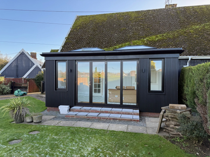 Black-clad contemporary orangery with two lanterns