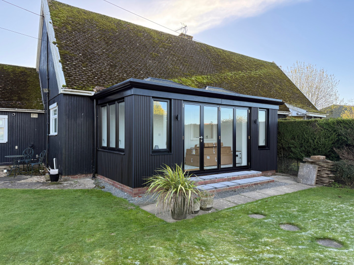 Black-clad contemporary orangery with two lanterns