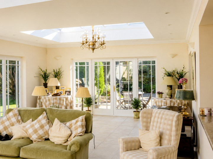 Brick orangery with two roof lanterns, French doors, parapet wall