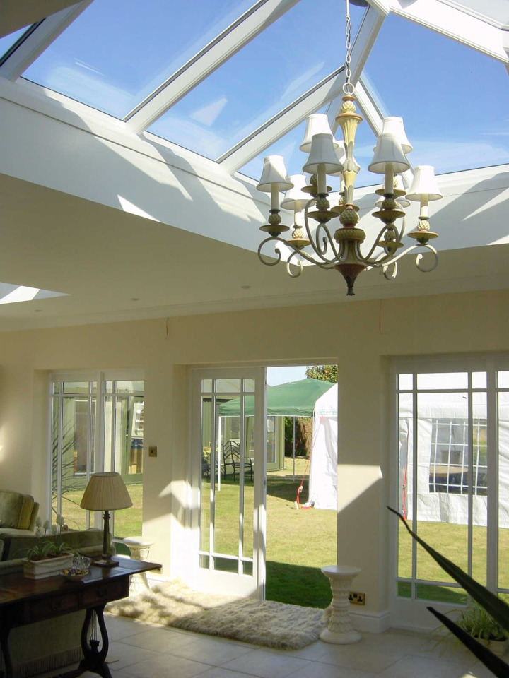 Brick orangery with two roof lanterns, French doors, parapet wall