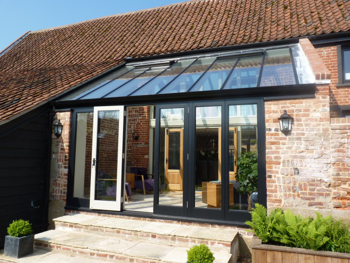 Lean-to Conservatory with double storey roof for a listed barn, Norfolk