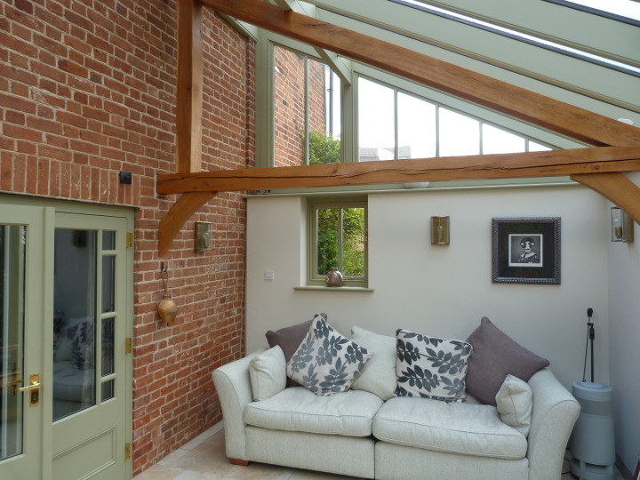 Traditional style lean-to conservatory with timber-clad section