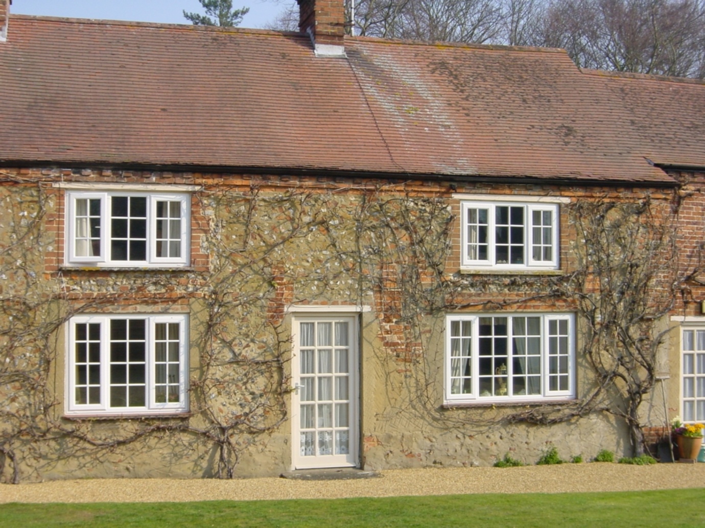 Traditional-style white UPVC windows and French Doors for a Norfolk country home