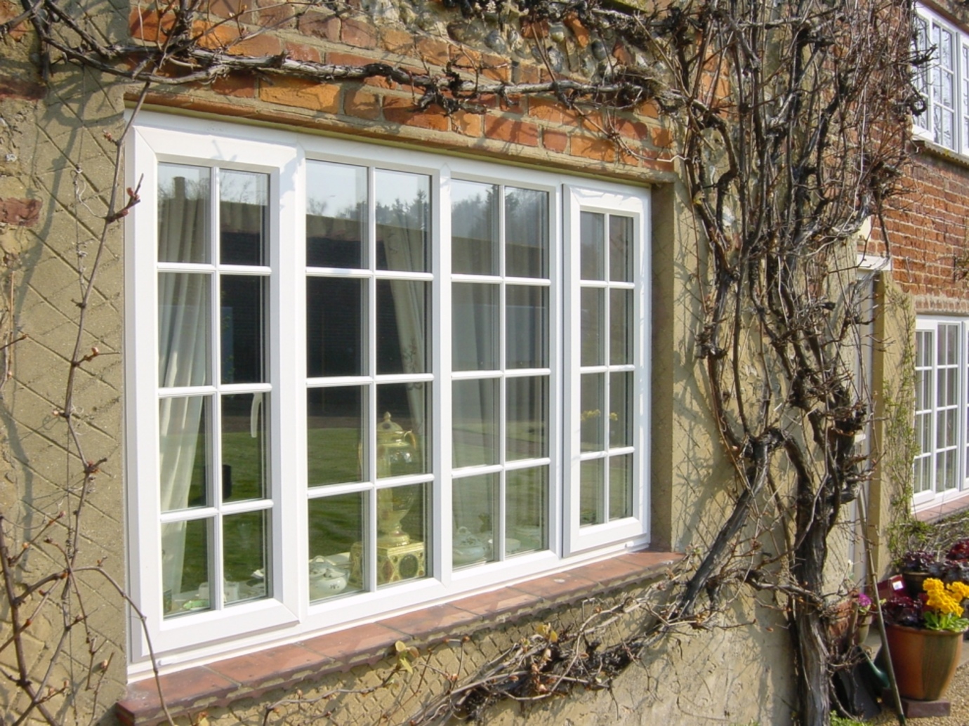 Traditional-style white UPVC windows for a Norfolk country home