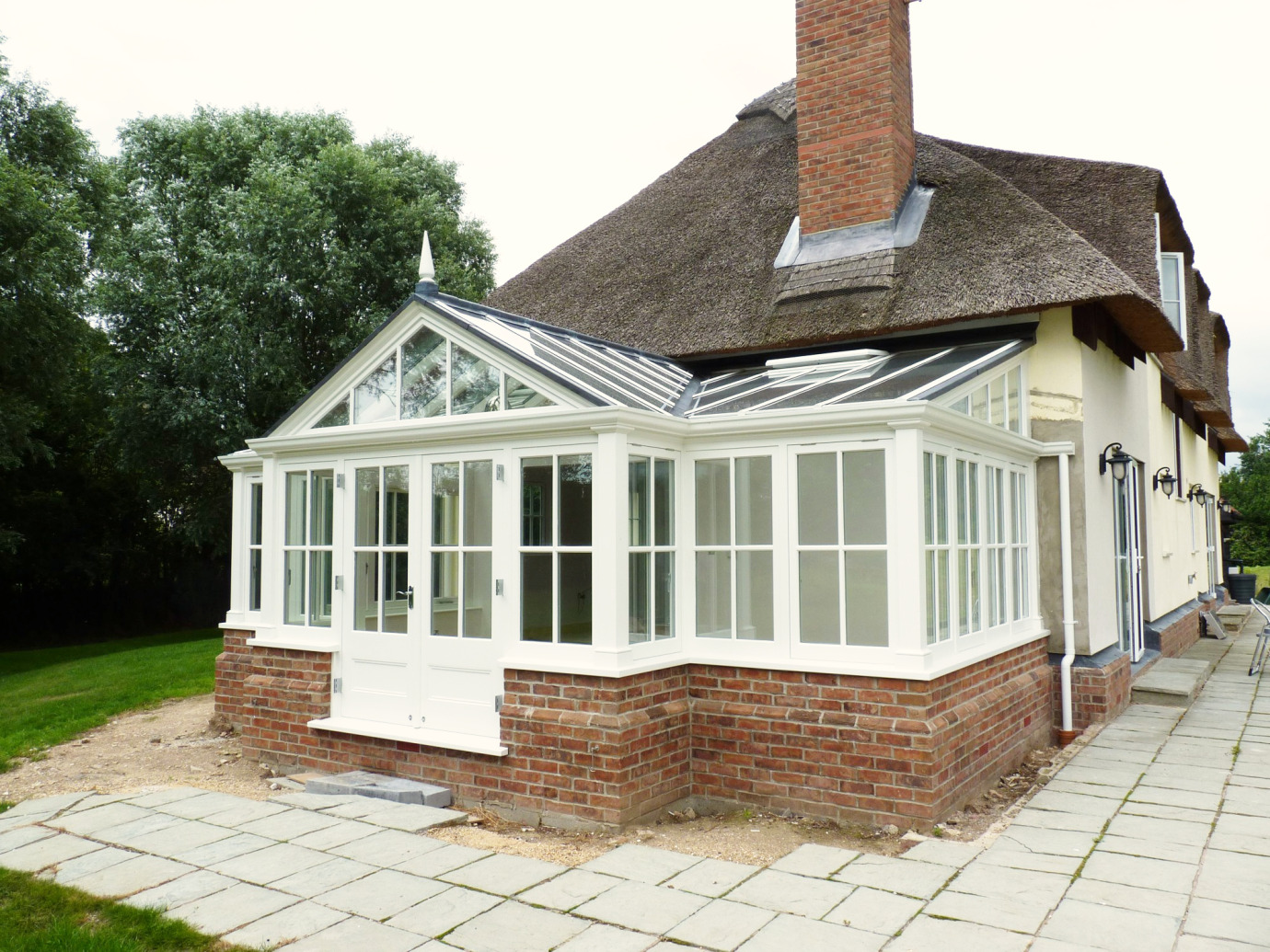 Gable conservatory with 4-pane Georgian detail, thatched cottage