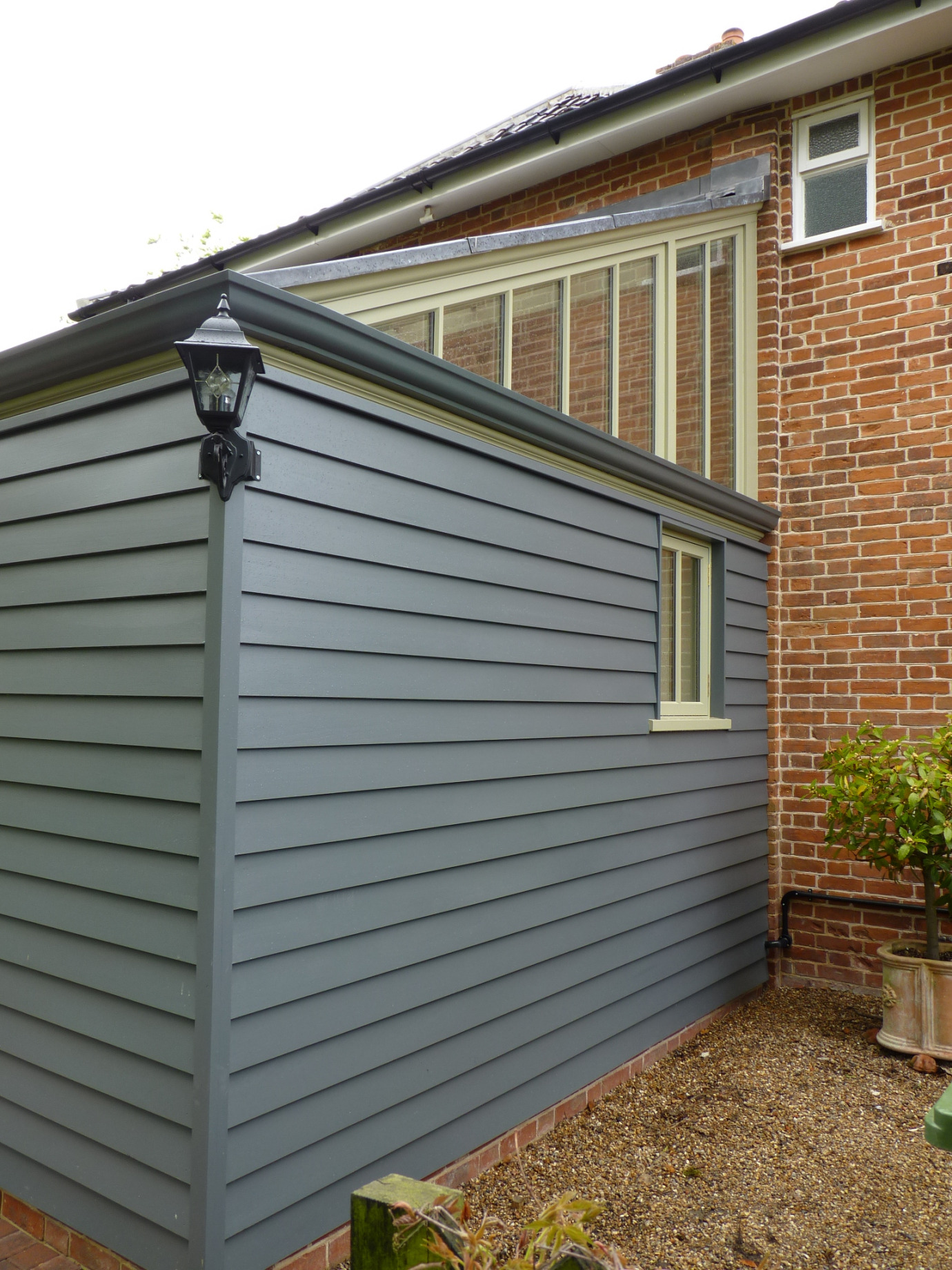 Traditional style lean-to conservatory with timber-clad section