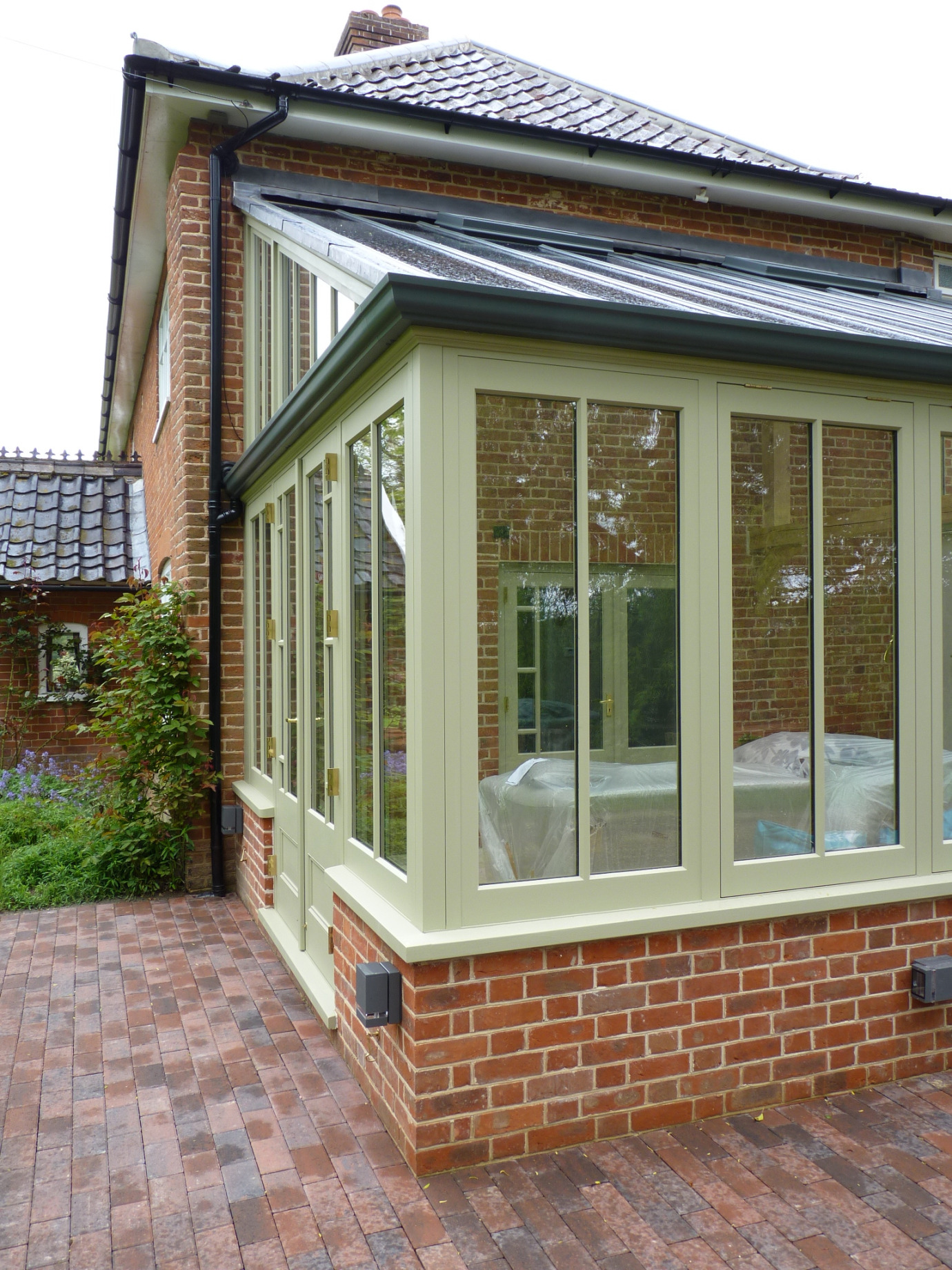 Traditional style lean-to conservatory with timber-clad section