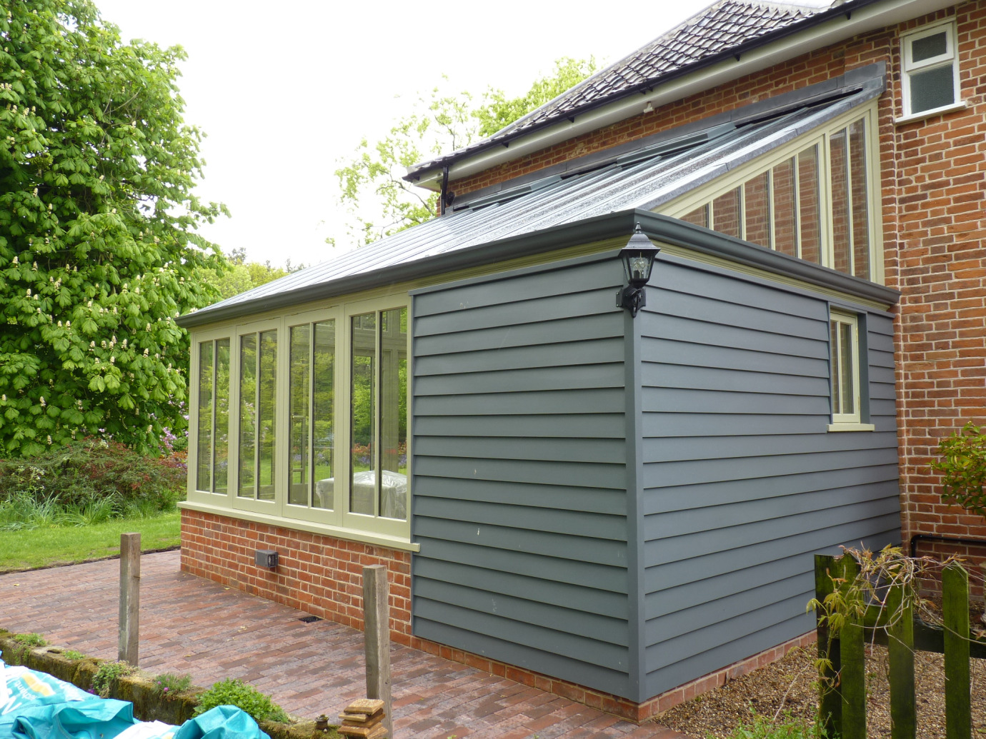 Traditional style lean-to conservatory with timber-clad section