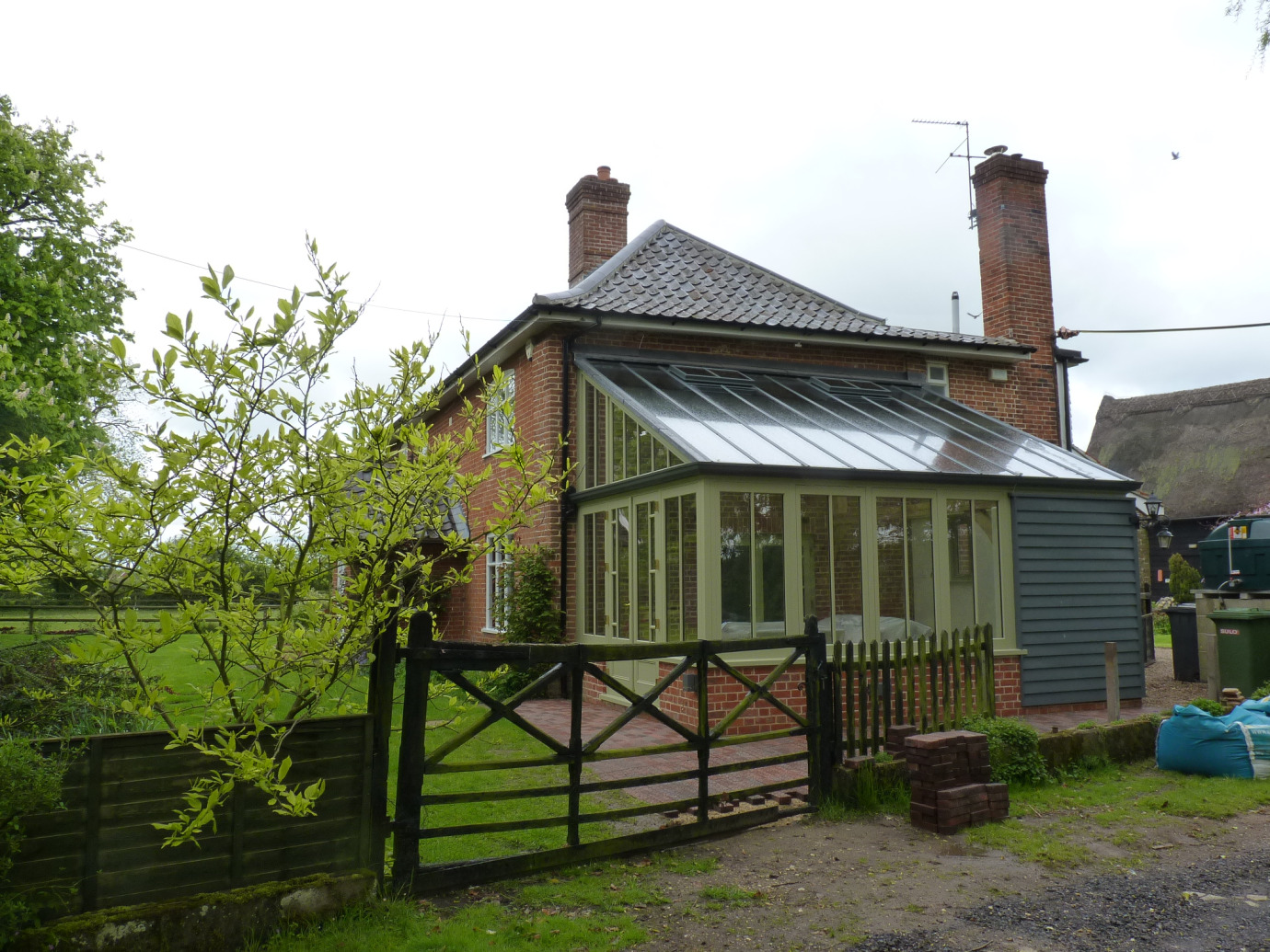 Traditional style lean-to conservatory with timber-clad section