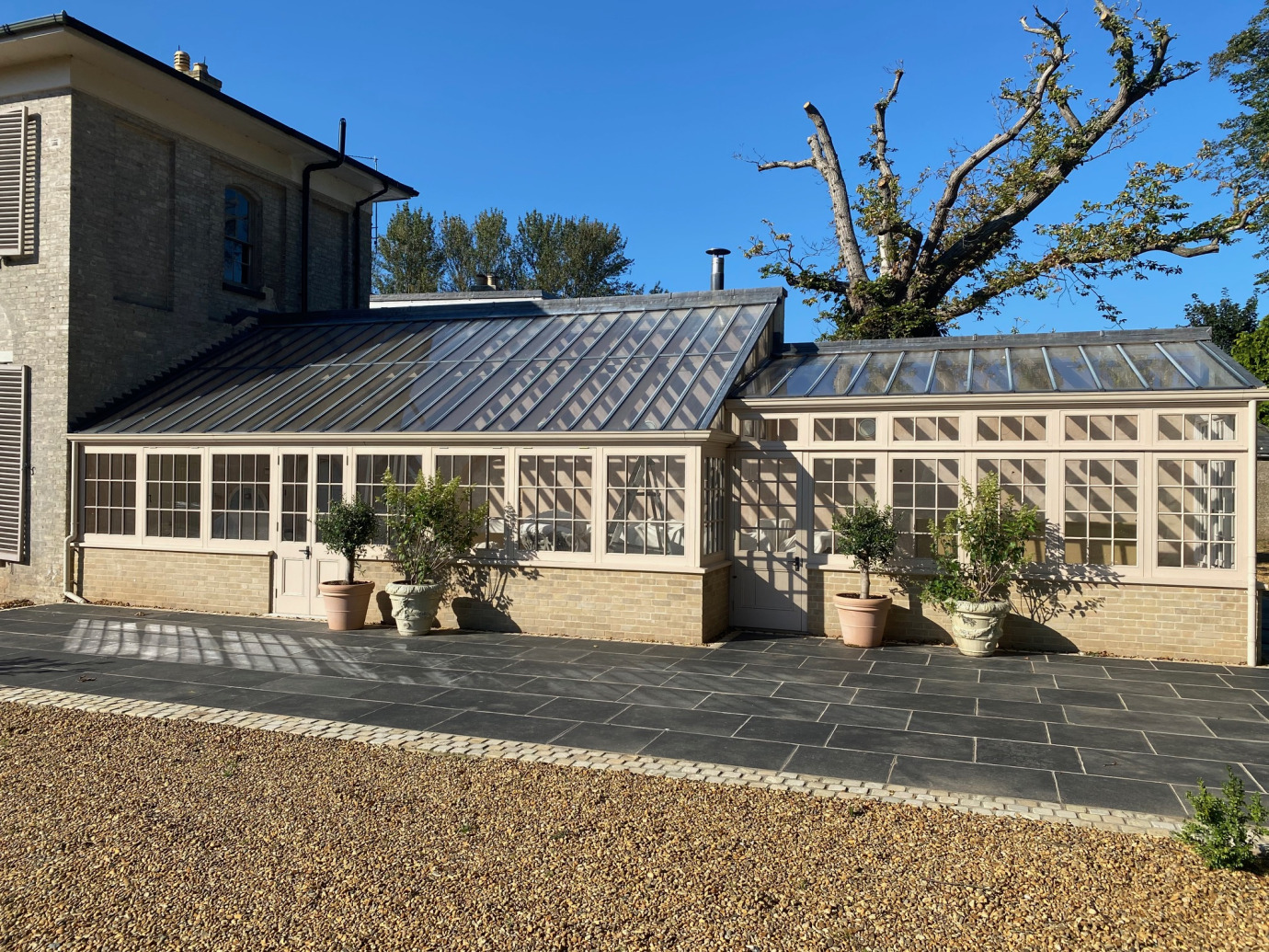 A splendid replacement greenhouse built against a spine wall with lead cappings